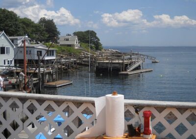 A serene harbor scene featuring a boat peacefully docked, surrounded by calm waters and distant shoreline.